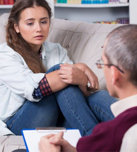 Teenager receiving guidance from therapist