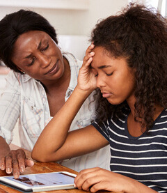 Parent providing emotional support to their teenager